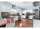 Modern kitchen with white cabinetry, stainless steel appliances, mosaic backsplash, and hardwood floors at 8523 Albury Walk Ln, Charlotte, NC 28277