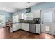 View of kitchen featuring stainless appliances, hardwood floors, and a door with doggie door at 8523 Albury Walk Ln, Charlotte, NC 28277