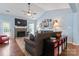 Bright living room with fireplace, ceiling fan, hardwood floors and large TV over the mantle at 8523 Albury Walk Ln, Charlotte, NC 28277