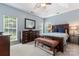 Comfortable bedroom with tray ceiling, large windows, lots of natural light, dresser and queen-sized bed at 8523 Albury Walk Ln, Charlotte, NC 28277