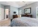 Spacious main bedroom featuring two dressers, large mirror, a ceiling fan, and a view into the main bathroom at 8523 Albury Walk Ln, Charlotte, NC 28277