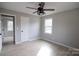 Bedroom features a ceiling fan, light-colored walls and floors, and natural light from a window at 868 Monarch Pl, Kershaw, SC 29067