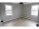 Bright bedroom featuring new floors, neutral paint, a ceiling fan and two large windows at 868 Monarch Pl, Kershaw, SC 29067