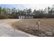 Wide shot of house with front yard, long driveway, and mailbox at 868 Monarch Pl, Kershaw, SC 29067