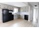 Modern kitchen featuring stainless steel appliances, white cabinets, and hardwood floors at 868 Monarch Pl, Kershaw, SC 29067