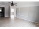 Spacious living room featuring a decorative brick wall, hardwood floors and ceiling fan at 868 Monarch Pl, Kershaw, SC 29067