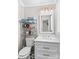 Clean bathroom with white vanity, toilet, and shelving unit at 111 Lois Ct, Statesville, NC 28625
