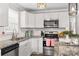 Updated kitchen with white cabinets, granite countertops, and stainless steel appliances at 111 Lois Ct, Statesville, NC 28625