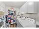 Laundry room with washer, dryer, and storage shelves at 111 Lois Ct, Statesville, NC 28625