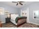 Bedroom with wooden bed frame and window view at 13913 Queens Harbor Rd, Charlotte, NC 28278