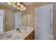 Double vanity bathroom with a large mirror and updated light fixture at 15127 Alijon Ct, Charlotte, NC 28278