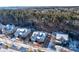 Aerial view of a gray home with a three car garage surrounded by snow covered ground and trees at 17627 Caddy Ct, Charlotte, NC 28278