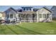 Well-manicured lawn and a screened in porch perfect for enjoying outdoor living and entertaining at 17627 Caddy Ct, Charlotte, NC 28278