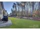 Backyard featuring a well-maintained lawn, landscape border, and outdoor entertaining space at 17627 Caddy Ct, Charlotte, NC 28278