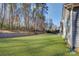 Spacious backyard featuring a well-maintained lawn and a border of mature trees and landscape at 17627 Caddy Ct, Charlotte, NC 28278