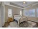 Bright bedroom with brass bed frame and hardwood floors at 17627 Caddy Ct, Charlotte, NC 28278
