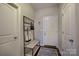 Inviting entryway features coat rack, bench, and storage area for shoes and accessories at 17627 Caddy Ct, Charlotte, NC 28278