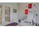 Home office with white desk, comfortable chair, and glass doors at 17627 Caddy Ct, Charlotte, NC 28278