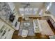 Aerial view of living room featuring stone fireplace, high ceilings, and natural light at 17627 Caddy Ct, Charlotte, NC 28278