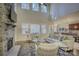 Open living room with stone fireplace, high ceilings, and view to kitchen at 17627 Caddy Ct, Charlotte, NC 28278