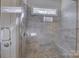 Walk-in shower with tiled walls and a pebble floor at 17627 Caddy Ct, Charlotte, NC 28278