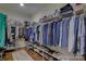 Spacious walk-in closet featuring ample storage, shelving, and clothing racks on hardwood floors at 17627 Caddy Ct, Charlotte, NC 28278