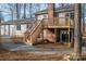Backyard featuring a wooden deck with stairs leading down to a gravel area and a brick patio under the deck at 1934 Hickory Hills Dr, Denver, NC 28037