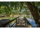 Picturesque view of the lake from the backyard dock, surrounded by lush greenery and calm waters at 1934 Hickory Hills Dr, Denver, NC 28037