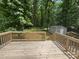 Spacious wooden deck overlooking a lush green backyard with a shed and mature trees, offering a serene outdoor space at 1934 Hickory Hills Dr, Denver, NC 28037