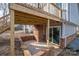 Backyard featuring a wooden deck above a brick patio and gravel area, perfect for outdoor enjoyment at 1934 Hickory Hills Dr, Denver, NC 28037