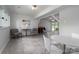 Finished basement with tiled floors, multiple seating areas, and large windows at 1934 Hickory Hills Dr, Denver, NC 28037