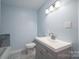 Cozy bathroom featuring a stylish vanity with a white countertop and ample storage space at 1934 Hickory Hills Dr, Denver, NC 28037