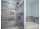Modern bathroom showcasing a fully tiled shower with a built-in niche and a separate bathtub at 1934 Hickory Hills Dr, Denver, NC 28037