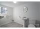 A clean and bright bathroom with a pedestal sink, toilet, and a window, offering a functional space at 1934 Hickory Hills Dr, Denver, NC 28037