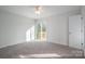 Spacious bedroom with plush carpeting, neutral tones, and sliding glass doors to a private deck at 1934 Hickory Hills Dr, Denver, NC 28037