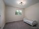 Small bedroom with carpeted floors, window view and twin bed at 1934 Hickory Hills Dr, Denver, NC 28037