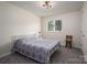 Bedroom featuring a queen bed with soft gray carpet and great natural light at 1934 Hickory Hills Dr, Denver, NC 28037