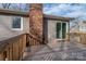 Wooden deck featuring a brick chimney and overlooking the backyard, perfect for outdoor relaxation and entertaining at 1934 Hickory Hills Dr, Denver, NC 28037
