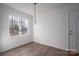 Simple dining area with wood flooring and a view to the backyard at 1934 Hickory Hills Dr, Denver, NC 28037
