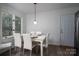 Cozy dining room features a wooden table, white chairs, and a view to the outside at 1934 Hickory Hills Dr, Denver, NC 28037