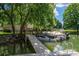 Picturesque waterfront view showcasing a wooden dock and serene, boat-filled waters at 1934 Hickory Hills Dr, Denver, NC 28037
