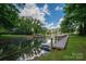 Scenic waterfront view featuring a private dock, lake, and lush greenery enhancing the property's charm at 1934 Hickory Hills Dr, Denver, NC 28037