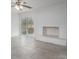 Bright Gathering room features a fireplace with white brick surround and sliding glass doors to patio at 1934 Hickory Hills Dr, Denver, NC 28037