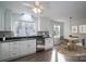 Bright kitchen featuring white cabinets, stainless steel appliances, and a cozy dining area at 1934 Hickory Hills Dr, Denver, NC 28037