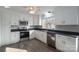 Modern kitchen with white cabinets, stainless steel appliances, and ample counter space at 1934 Hickory Hills Dr, Denver, NC 28037