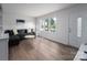 Bright living room with large windows, a gray couch, and modern flooring at 1934 Hickory Hills Dr, Denver, NC 28037