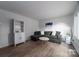 Bright living room features hardwood floors, a comfortable sofa, and stylish shelving at 1934 Hickory Hills Dr, Denver, NC 28037