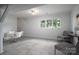 Bright and airy living area with neutral tile flooring, contemporary seating, and ample natural light at 1934 Hickory Hills Dr, Denver, NC 28037