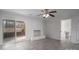 Living room with a white brick fireplace, updated floors, sliding doors leading to a deck, and an entrance to the bathroom at 1934 Hickory Hills Dr, Denver, NC 28037
