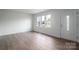 Simple living room with hardwood floors and large windows at 1934 Hickory Hills Dr, Denver, NC 28037